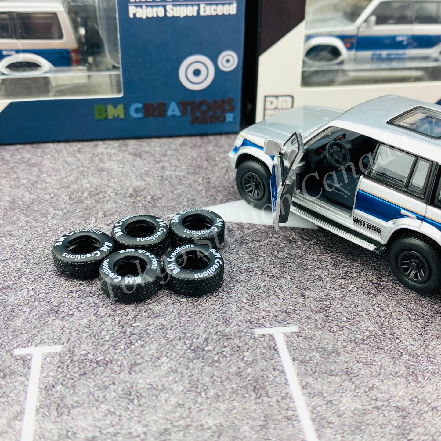 BM CREATIONS JUNIOR 1/64 Mitsubishi Pajero Super Exceed Silver with Blue Stripe LHD 64B0037