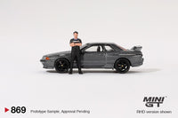 PREORDER MINI GT 1/64 Nissan Skyline GT-R (R32) Nismo Gunmetal w/ Matsuda Figure (Tsugio Matsuda Collection) MGT00869-R (Approx. Release Date : Q1 2025 subject to manufacturer's final decision)