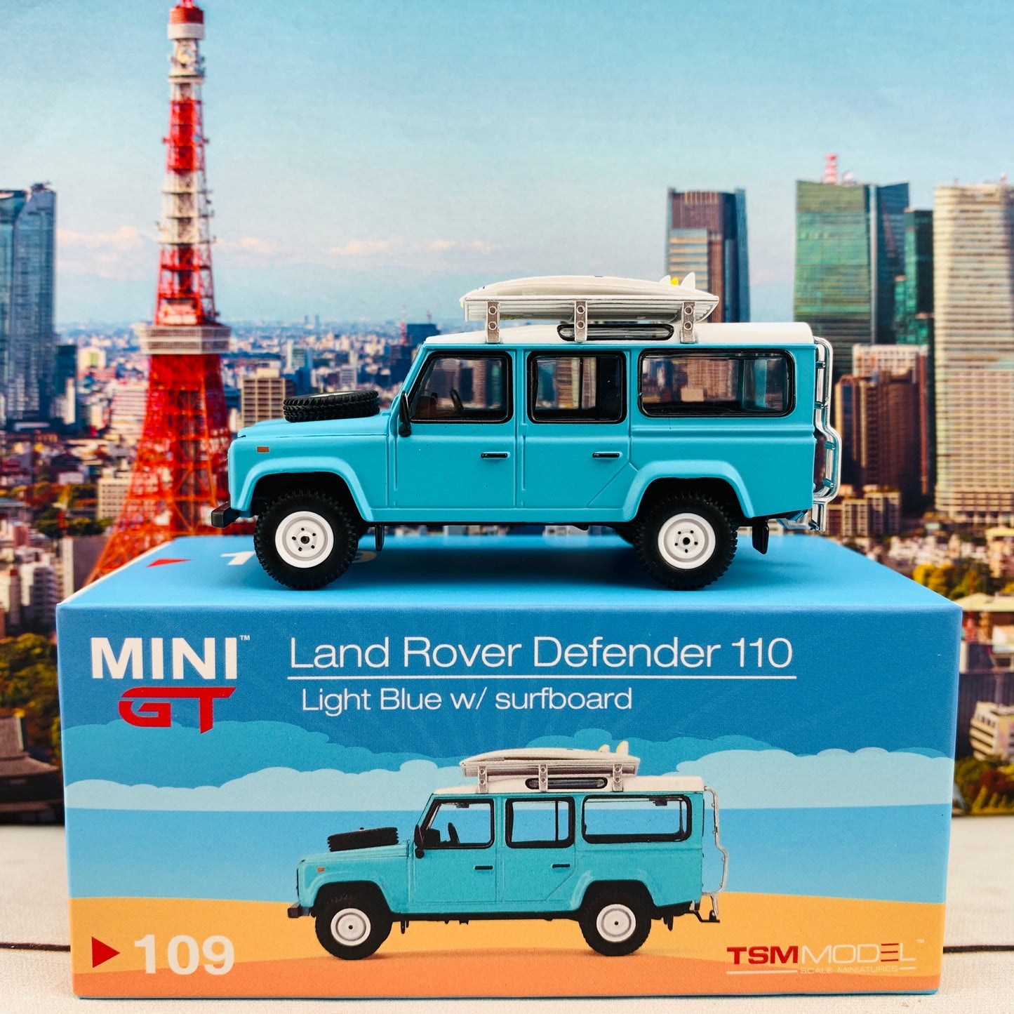 MINI GT 1/64 Land Rover Defender 110  Light Blue w/ Surfboard RHD MGT000109-R