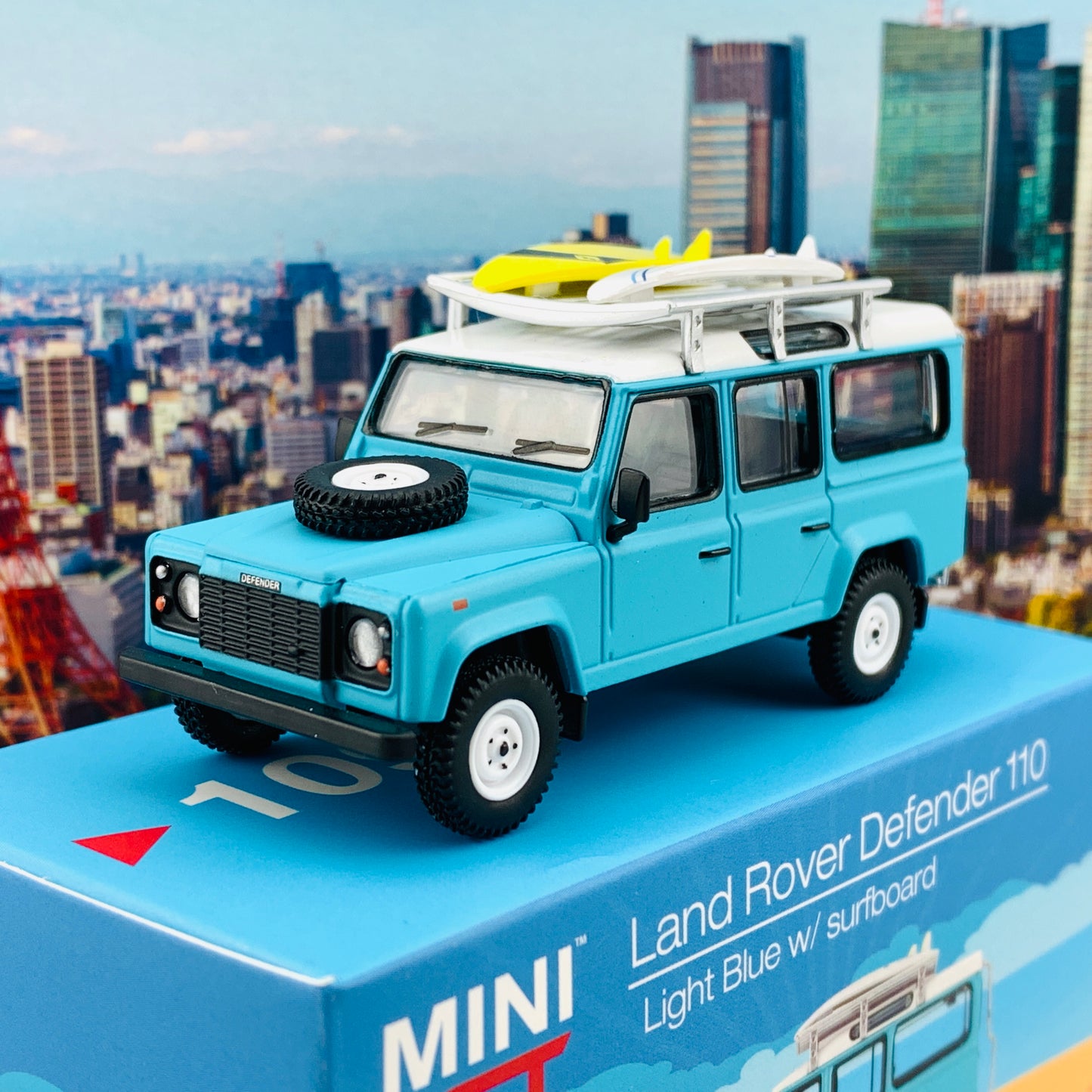 MINI GT 1/64 Land Rover Defender 110  Light Blue w/ Surfboard RHD MGT000109-R