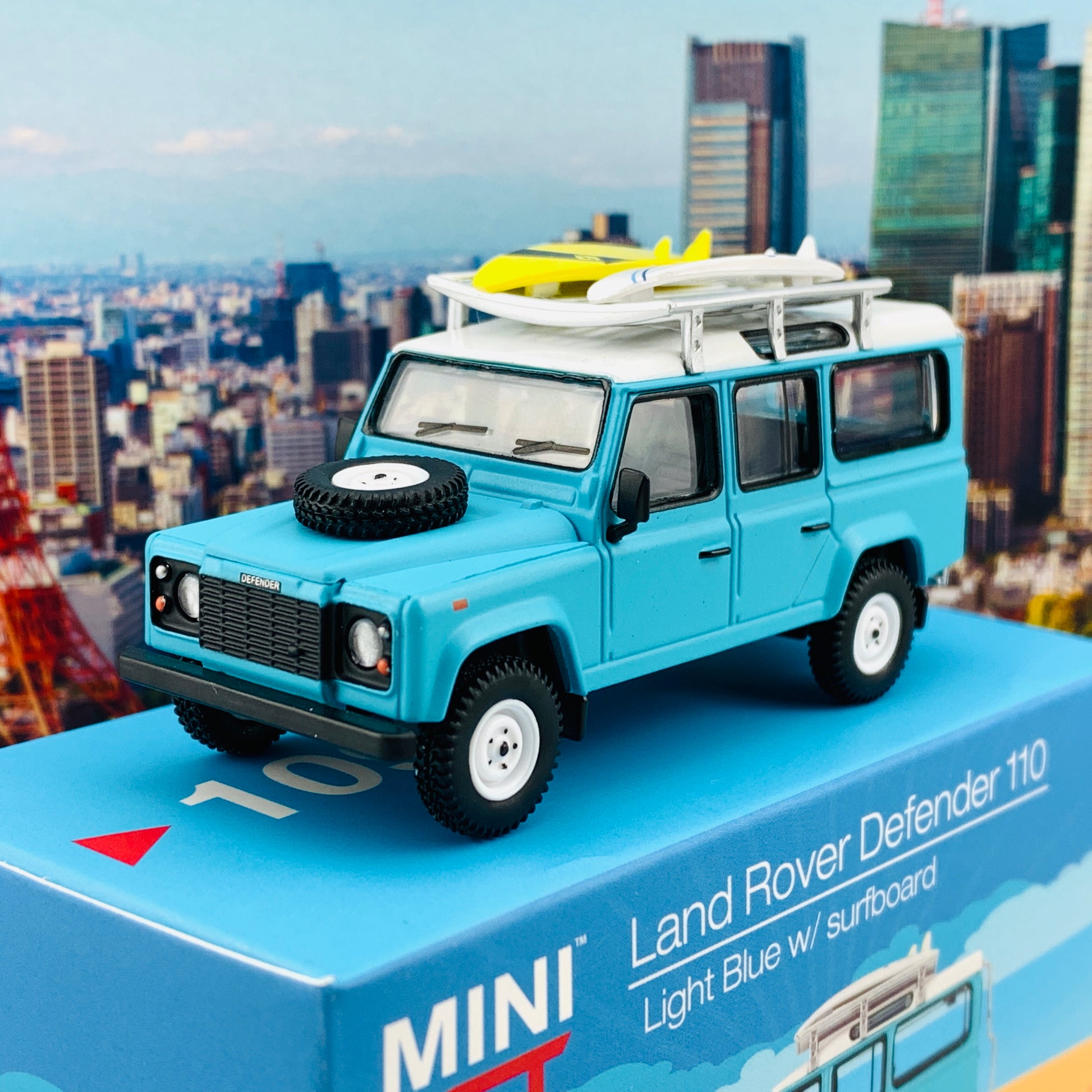 MINI GT 1/64 Land Rover Defender 110  Light Blue w/ Surfboard RHD MGT000109-R
