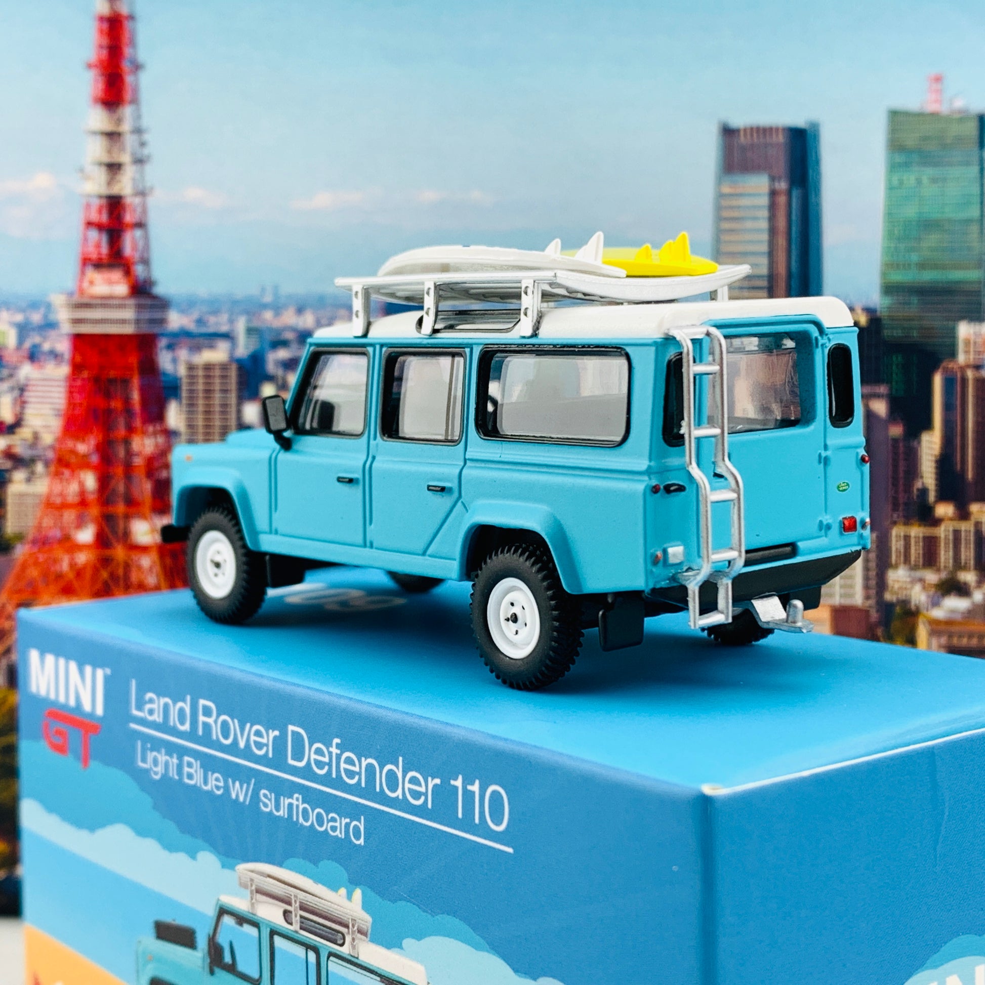 MINI GT 1/64 Land Rover Defender 110  Light Blue w/ Surfboard RHD MGT000109-R