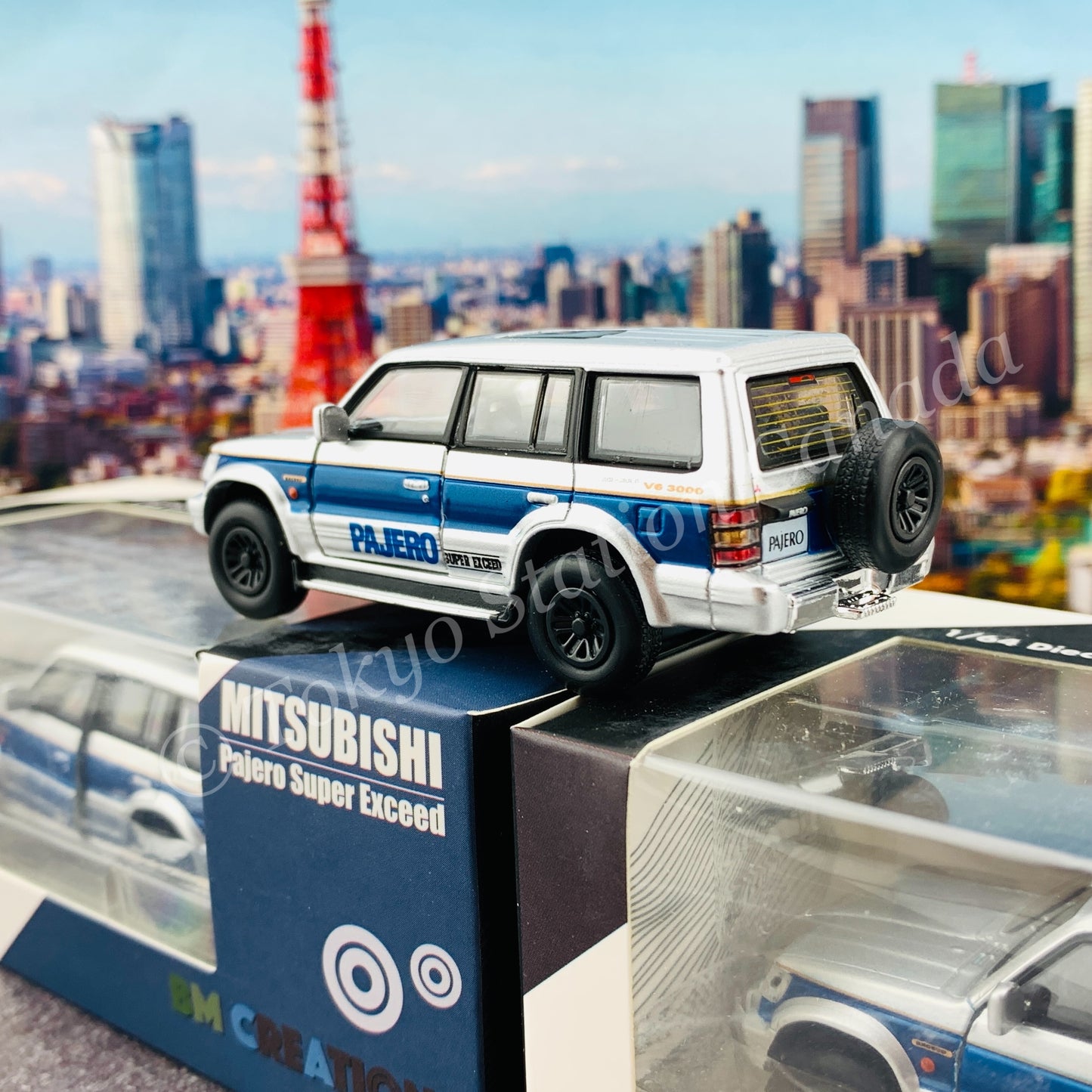 BM CREATIONS JUNIOR 1/64 Mitsubishi Pajero Super Exceed Silver with Blue Stripe LHD 64B0037