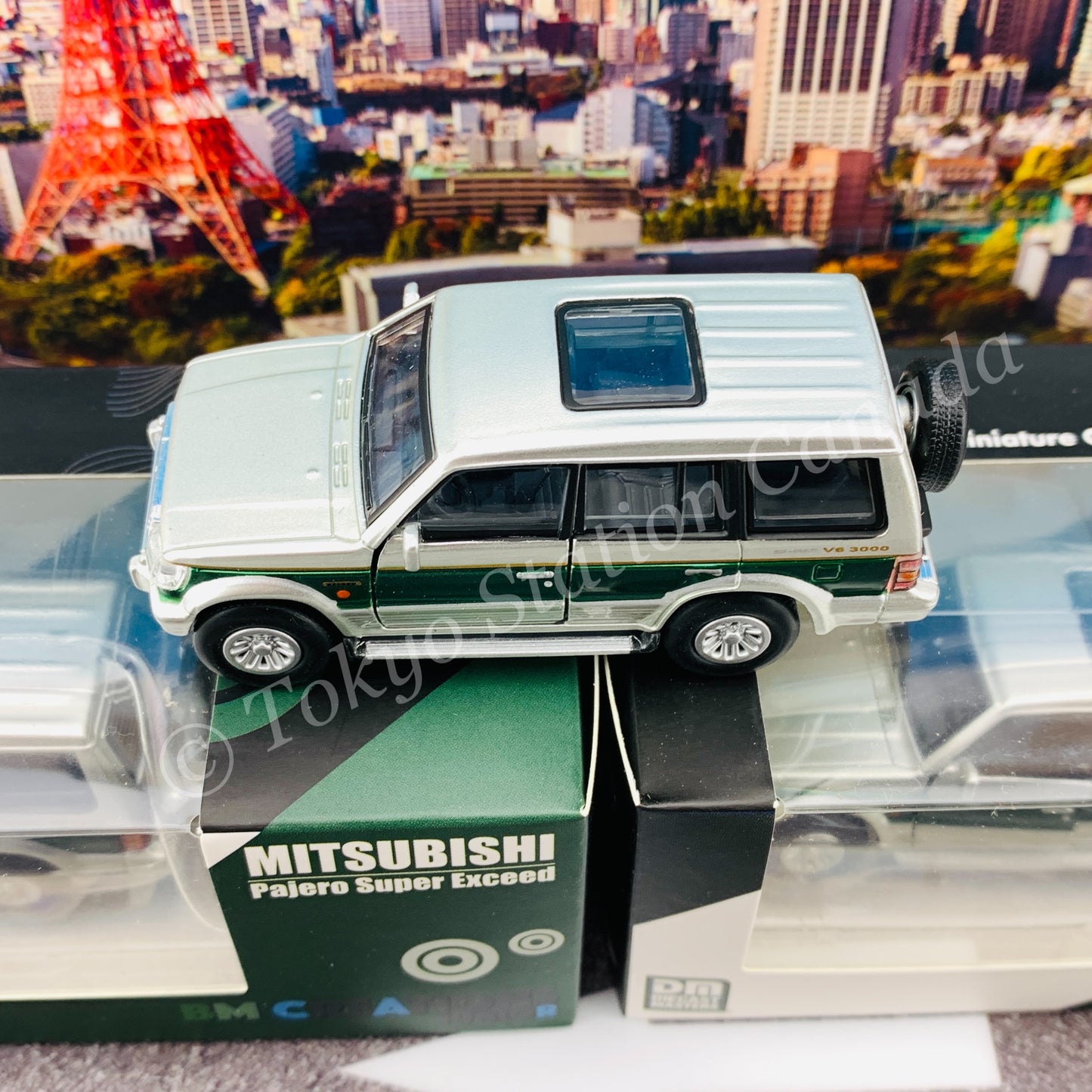 BM CREATIONS JUNIOR 1/64 Mitsubishi Pajero Super Exceed Silver with Green Stripe LHD 64B0020
